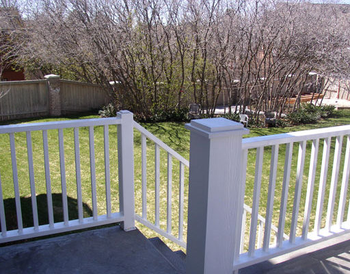 Grey composite deck material with white railing